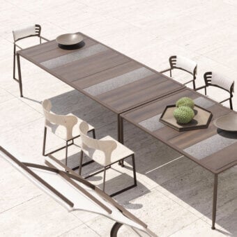 Distinguished Giorgetti Gea table crafted with carob aluminum, stone oak, and Etna lava stone surfaces exhibiting a contemporary finish