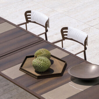 Exceptional Giorgetti Gea table built with stone oak, Afrormosia wood, and carob powder-coated aluminum in a satin finish