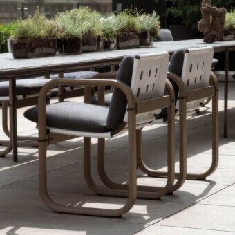 Distinguished Giorgetti Loop armchair with fluid lines and resilient Eva rubber cushions in darker grey waterproof textile crafted with grey water-polished ash wood and carob aluminum