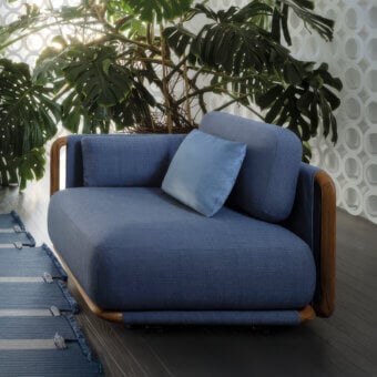 Elegant Giorgetti Moorea lounge chair with deep blue textile upholstery and warm painted teak inserts built with a pewter-painted stainless steel frame