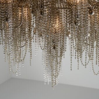 Distinguished Patrizia Garganti Burlesque chandelier with cascading clear and golden beads draped over a textured brass-toned metal frame