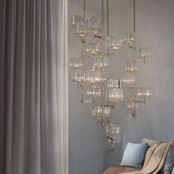 Distinguished Patrizia Garganti Novecento EX04 chandelier with 24 clear cut crystal shades and polished gold-tone metallic structure