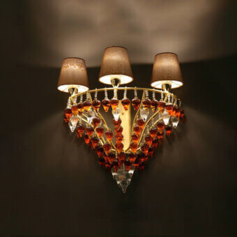 Exceptional Patrizia Garganti Ophelia wall lamp with amber and orange glass prisms, clear crystal accents, and a polished golden-toned metal frame