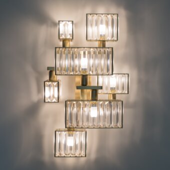Architectural Patrizia Garganti Tur wall lamp crafted in polished brass with clear glass exhibiting a balanced layered composition