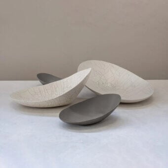 Superior Rina Menardi Baccelli Seduti centerpiece in light and medium gray baked clay with undulating edges and a smooth matte finish