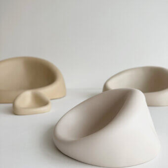 Elegant Rina Menardi Clio centerpiece crafted from baked clay with an organic asymmetrical form and pale creamy beige hue