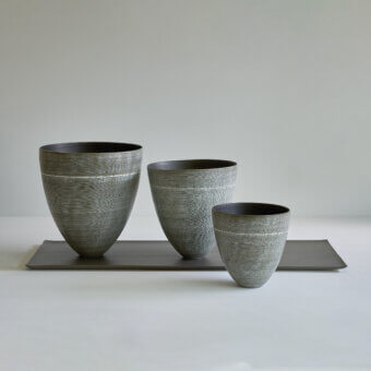 Distinguished Rina Menardi Coppe vase set crafted in baked clay with incised lines and a muted gray matte finish
