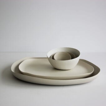 Distinguished Rina Menardi Quadritondi centerpiece with nested bowls and plates in warm grey matte ceramic