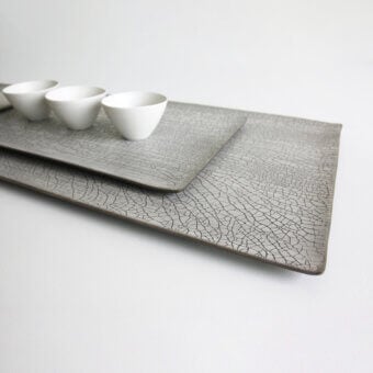 Distinguished Rina Menardi Vassoi Rettangolari tray set with uniquely cracked muted gray finish crafted for decorative use
