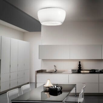Elegant Vistosi Implode ceiling lamp crafted in multi-layered glass with gradation between white and transparent crystal and satin metallic perimeter