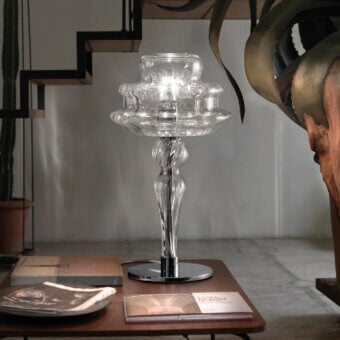 Elegant Vistosi Novecento table lamp crafted with clear glass and dark metal, exhibiting a signature rigadin finish