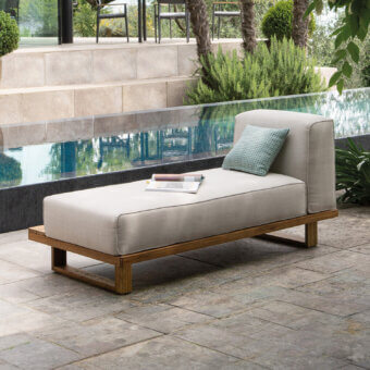 Refined Atmosphera 9.Zero chaise lounge in solid Asian Teak with satin finish and woven textile, accented with a muted teal cushion