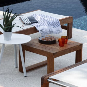 Elegant Atmosphera Desert side table crafted from solid Indonesian Teak wood with honey-toned brown grain and satin oil finish