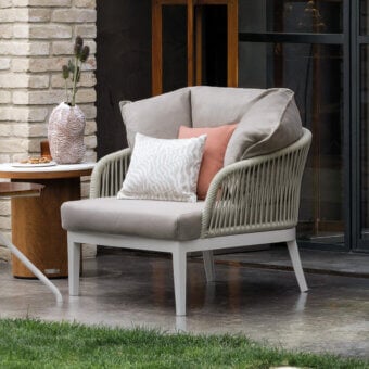Distinguished Atmosphera Dream 2.0 lounge chair with a hand-woven light-colored frame and plush beige fabric seat