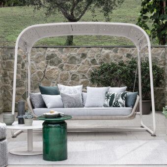Distinguished Atmosphera Ludo freestanding swing with a galvanized iron frame and light gray synthetic fiber woven seat in gray, teal, and black cushions