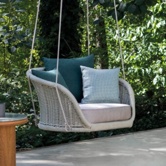 Distinctive Atmosphera Ludo swing with sculpted resin wicker and comfortable teal gray cushions offers weightless luxury for open-air living