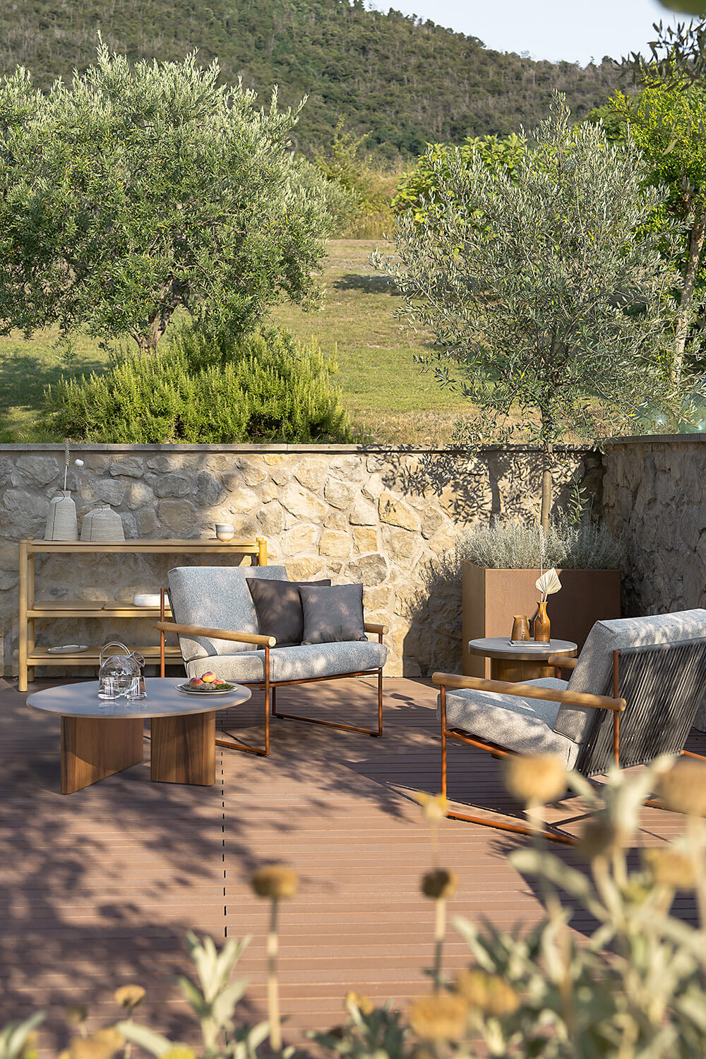 Elegant Atmosphera Materia coffee table with a round glossy glazed lava stone tabletop and solid Asian Teak base