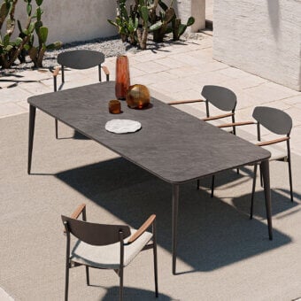 Distinguished Atmosphera Origami table with folded silhouette and resilient gres porcelain stoneware tabletop in dark gray with matte finish