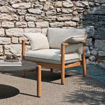 Distinctive Atmosphera Panama lounge chair with cylindrical teak frame and neutral beige textile upholstery in satin finish