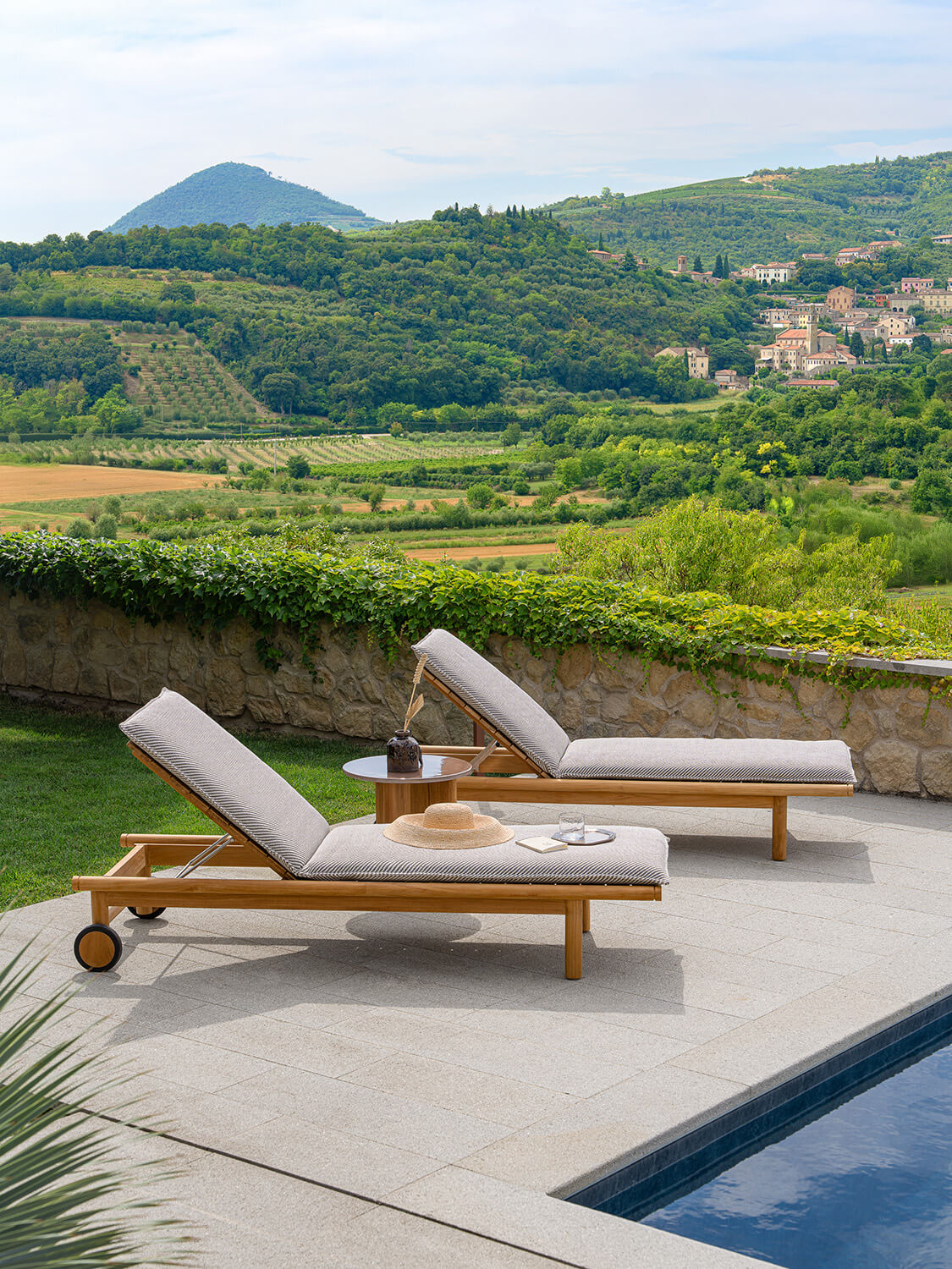 Distinguished Atmosphera Panama lounger with sculpted teak structure and light gray textured slats exhibiting a satin finish