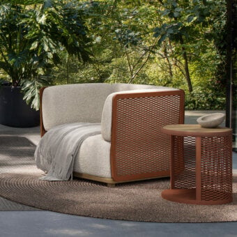 Superior Atmosphera Switch Lounge chair with textured beige bouclé and perforated reddish-brown metal frame crafted with aluminum base