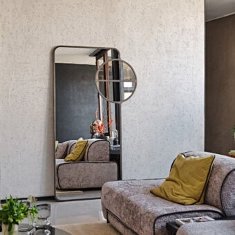 Superior Black Tie Mou mirror crafted with dark bronze metal and tonal variations in glass for a refined presence