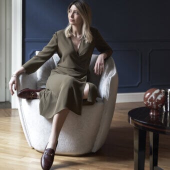 Superior Capital Audrey lounge chair upholstered in subtly textured neutral beige fabric with a refined metal plinth base