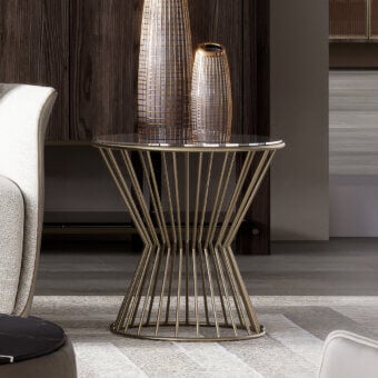 Distinguished Capital Khero side table with a sleek round glass top and intricately designed golden metallic base crafted in Italy with a glossy finish