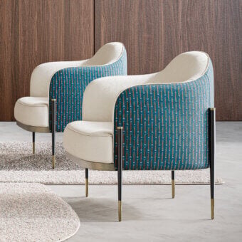 Refined Capital Oxford lounge chair upholstered in patterned teal and brown textile with brass and dark gray metal legs crafted in Italy