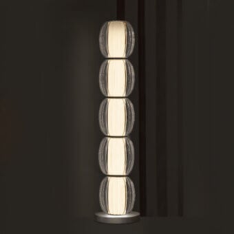 Exceptional Contardi Alma Totem floor lamp with stacked translucent modules and brushed metal base emitting a creamy white glow