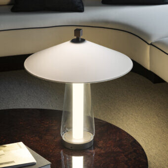 Elegant Contardi Asia table lamp with a gently curved white shade and clear glass column crafted from fabric, glass and metal