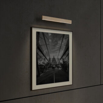 Refined Contardi Fly Picture lamp with sleek metal body and satin finish gently illuminates artwork in a white aesthetic