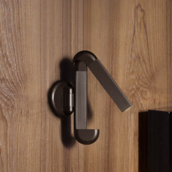 Superior Contardi Picchio wall lamp crafted in dark-toned metal with a matte and bronze-hued aesthetic offering adjustable flexibility