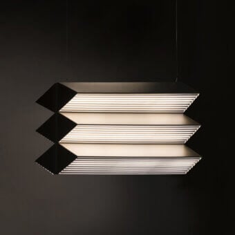 Architectural Contardi Stick Trio suspension lamp crafted in sleek metal with a matte black finish emits warm diffused light