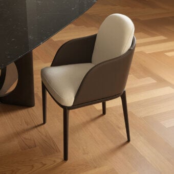 Exceptional Horm Piccadilly armchair upholstered in textured neutral beige textile with dark brown leather-like detailing and angled metal legs