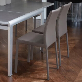 Distinguished Ivano Antonello Italia Lucy dining chair with steel and refined leather upholstery in muted taupe finish