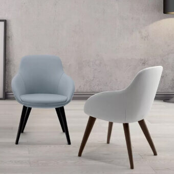 Elegant Ivano Antonello Italia Simona armchair with rounded silhouette upholstered in light blue textile and beech wood base