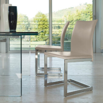 Elegant Ivano Antonello Italia Sonia dining chair with pale beige textile and polished silver-grey metal frame