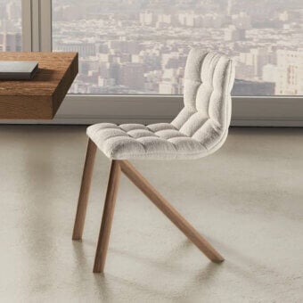 Distinguished Lago Mezz’aria chair with quilted neutral textile upholstery and angled wood frame construction