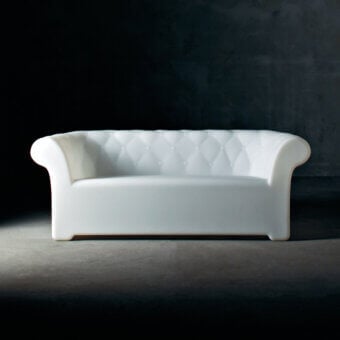Elegant Serralunga Sirchester sofa crafted from glossy white LLDPE plastic with deeply button-tufted design for comfortable outdoor living