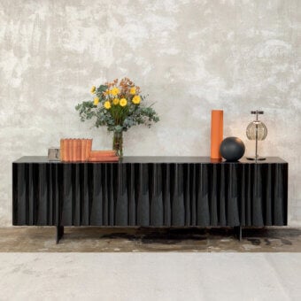 Exceptional Tonin Casa Bombé sideboard crafted in matte black lacquered wood with glossy black lacquered rounded slat doors and metal base