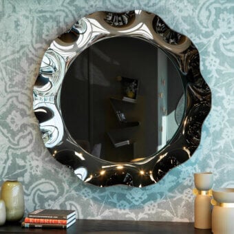 Elegant Tonin Casa Dorian mirror with corolla-shaped frame crafted in silvered curved glass enriched with bronze and fumè tones