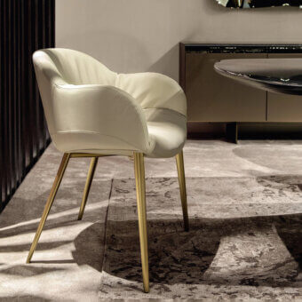 Exclusive Tonin Casa Olympia armchair upholstered in creamy off-white textile with polished golden metal legs and quilted backrest
