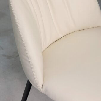 Sophisticated Tonin Casa Olympia chair upholstered in creamy off-white synthetic material with subtle vertical pleating and slender dark metal legs