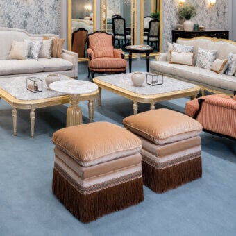 Luxury Bellotti Ezio ottoman in tan/beige velvet with shimmering finish, patterned trim blues whites oranges, dark-brown fringe