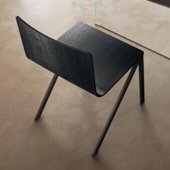 Captivating Lago Mezz’aria chair with dark muted gray wood seat and matte finish exhibiting a cantilevered form