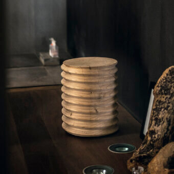Elegant Riva 1920 Vitae stool from solid walnut, light‑to‑medium brown with striking grain, darker knots, ribbed rings, flat top growth rings