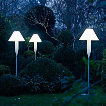 Elegant Serralunga Bonheur floor lamp with satin white shade and pale blue recyclable LLDPE, emitting ambient glow