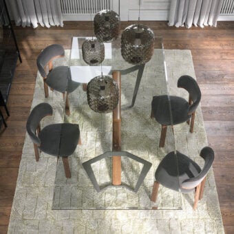 Elegant Tonin Casa Oliver table with transparent glass and a dark metal with solid wood base crafted in a medium tone