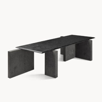 Distinguished Visionnaire Axiom table with dark charcoal stone and textured leather surface built on staggered block bases